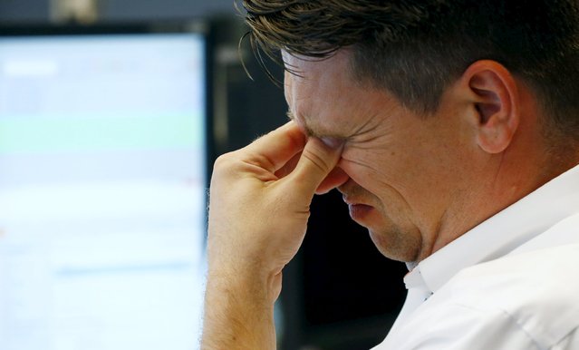 A trader reacts at his desk at the Frankfurt stock exchange, Germany, August 24, 2015. (Photo by Ralph Orlowski/Reuters)