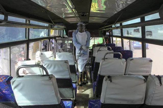 A man sprays disinfectant to sanitize a public bus against the spread of the new coronavirus, in downtown Nairobi, Kenya Thursday, March 19, 2020. (Photo by AP Photo/Stringer)