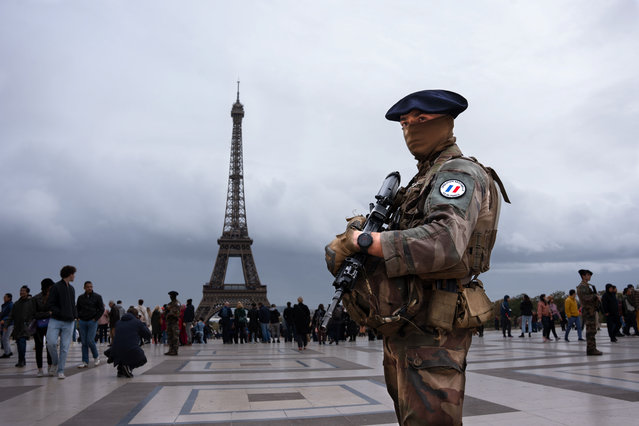 A French military man from “Operation Sentinelle” guards on October 21, 2023 the Trocadero area in front of the Eiffel Tower, crowded with tourists, as France is on high alert for terrorism due to the Palestinian-Israeli conflict. Dozens of French military and police are deployed throughout Paris because of multiple bomb threats. (Photo by Ximena Borrazas/SOPA Images/Rex Features/Shutterstock)
