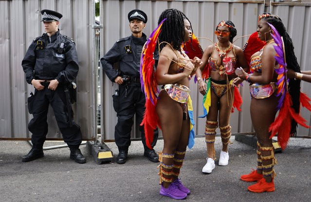 Participants in costumes arrive at the Notting Hill Carnival in London, Britain, 29 August 2022. The Notting Hill Carnival is the largest street carnival in Europe and returned to London after two year break due to the coronavirus pandemic with more than a million people expected to attend the two-day celebration of Caribbean heritage on 28 and 29 August. (Photo by Tolga Akmen/EPA/EFE)