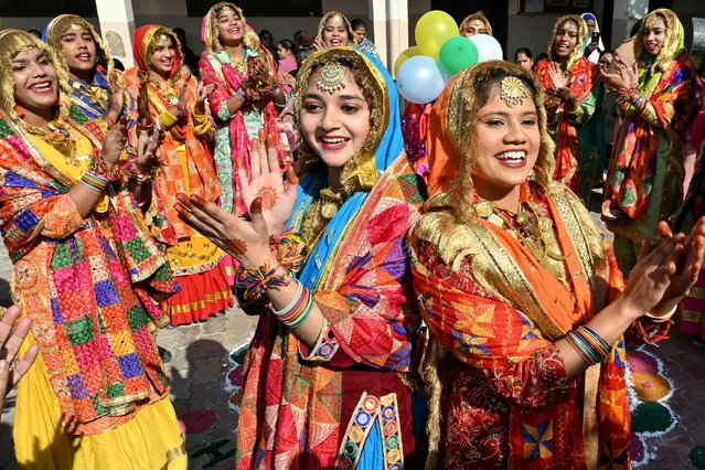 School girls perform Punjabi folk dance “Giddha” ahead of the upcoming 'Lohri' festival at a government school in Amritsar on January 8, 2025. (Photo by Narinder Nanu/AFP Photo)