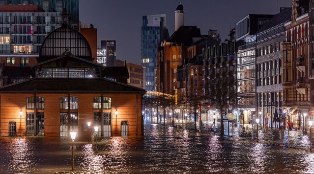 The fish market and surrounding streets on the Hamburg, Germany on December 22, 2023 waterfront are flooded following a storm surge. (Photo by Axel Heimken/AFP Photo)