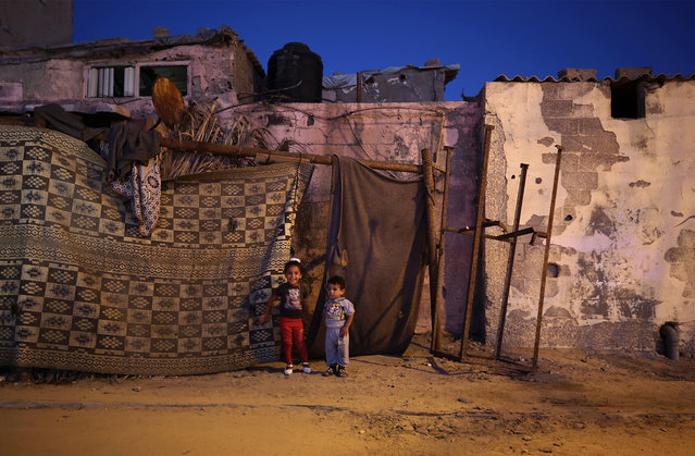 Palestinian refugee children play outside of their family house during a power outage at al Shateaa refugee camp, in Gaza City, 30 July 2017. The 1.8 million people who reside in Gaza, experience some 20 electricity outages per day. According to reports on 16 April 2017, the Gaza Strip sole functioning power station ran out of fuel and stopped working. The Gaza power Generating Company plant usually operates only eight hours a day, after its fuel crosses into Gaza through the Israeli Kerem Shalom border crossing. (Photo by Mohammed Saber/EPA)