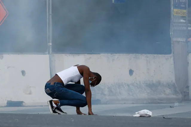 A protester tries to catch their breath on East Santa Clara Street during a protest decrying the police killing of George Floyd in downtown San Jose on Friday, May 29, 2020. (Photo by Randy Vazquez/Bay Area News Group)