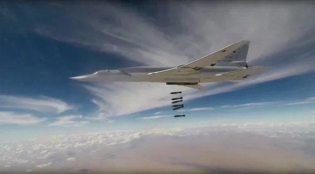 This photo made from the footage taken from Russian Defense Ministry official website Wednesday, November 1, 2017 shows a Russian Tu-22MZ bomber hitting positions of the militants outside the town of Al Bukamal on the border with Iraq in the eastern Deir el-Zour province, the epicenter of heavy fighting with the retreating IS militants. Russia's military says six of its long-range bombers have taken off from air bases in Russia to strike targets on the border between Syria and Iraq. (Photo by Russian Defense Ministry Press Service via AP Photo)