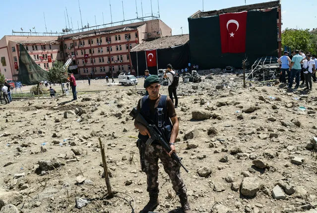 A Turkish soldiers stands guard in front of the blast scene following a car bomb attack on a police station in the eastern Turkish city of Elazig, on August 18, 2016.
At least three people were killed and another 120 injured on August 18, 2016 in a car bomb attack on a police headquarters in eastern Turkey, a local security source said. The explosion, blamed by Defence Minister Fikri Isik on the outlawed Kurdistan Workers' Party (PKK), happened in the garden of the four-storey building in Elazig. (Photo by Ilyas Akengin/AFP Photo)