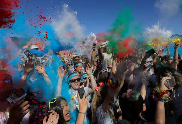 Multi-coloured dyes are thrown in the air by participants during the annual Sydney Color Run in Australia's largest city, August 21, 2016. (Photo by Jason Reed/Reuters)