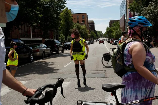 Marshal Sylvia Ildsjel blocks streets with other marshals in place of police as people march to support the LGBTQ community and the Black Lives Matter movement in Minneapolis, Minnesota, June 28, 2020. (Photo by Nicole Neri/Reuters)