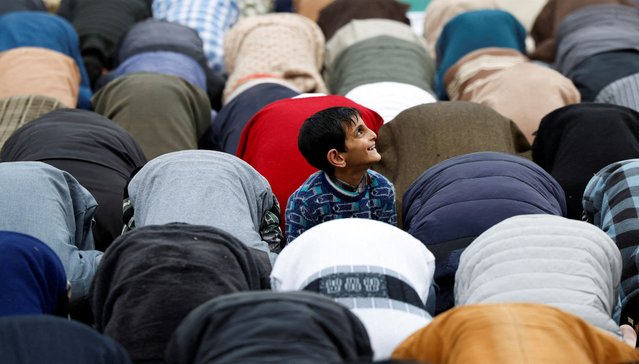 A boy looks at a drone as muslims offer prayers on the first Friday of the holy fasting month of Ramadan at Jamia Masjid in Srinagar, on March 7, 2025. (Photo by Sharafat Ali/Reuters)
