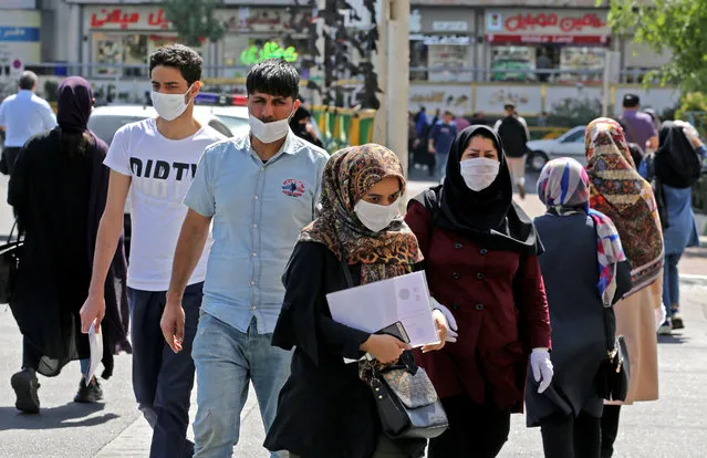 Iranians, mostly wearing face masks, are pictured in the capital Tehran on June 16, 2020 amid the coronavirus Covid-19 pandemic crisis. The Islamic republic has struggled to contain what has become the Middle East's deadliest outbreak of the COVID-19 illness since it reported its first cases in the Shiite holy city of Qom in February. (Photo by Atta Kenare/AFP Photo)