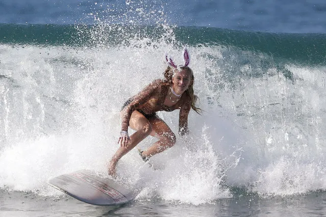 Vienna Werner, 16, rides a wave dressed as a rabbit during the 7th annual ZJ Boarding House Haunted Heats Halloween surf contest. (Photo by Lucy Nicholson/Reuters)
