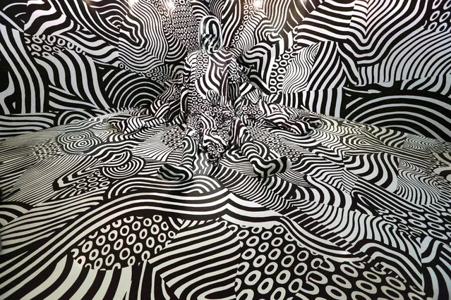 Model feebee poses as part of art installation “Narcissism : Dazzle room” made by artist Shigeki Matsuyama at rooms33 fashion and design exhibition in Tokyo, Wednesday, September 14, 2016. Matsuyama's installation features a strong contrast of black and white, which he learned from dazzle camouflage used mainly in World War I. (Photo by Eugene Hoshiko/AP Photo)