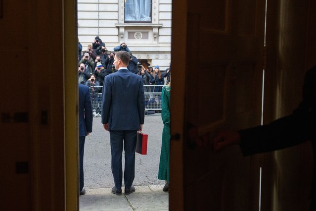 Britain's Chancellor of the Exchequer Jeremy Hunt carries the red Budget Box as he leaves from 11 Downing Street in central London on March 6, 2024, to present the government's annual budget to Parliament. Britain's Conservative government is on Wednesday expected to use a budget update to unveil tax cuts for millions of workers, in an attempt to woo voters before a general election. (Photo by Carl Court/Pool via AFP Photo)