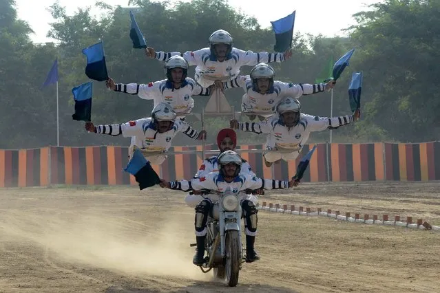 Indian Army soldiers from the Dare Devil team show off their skills as the 8th Mechanised Infantry (7 Punjab) celebrated its 75th year of raising (Platinum Jubilee) at Khasa, some 15 kms from Amritsar on September 16, 2016. The battalion was raised on May 5, 1941 and participated in the Burma campaign of World War 2 and all major operations post-independence. (Photo by Narinder Nanu/AFP Photo)