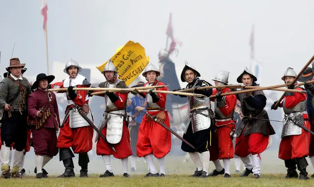 Participants wearing medieval costumes re-enact the 1620 battle of Bila Hora between Bohemian Estates and Austrian Imperial with Catholic forces in Prague, Czech Republic September 18, 2016. (Photo by David W. Cerny/Reuters)