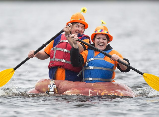 Paddlers race their giant pumpkins in the annual regatta on Lake Pisiquid in Windsor, Nova Scotia, Sunday, October 11, 2015. Participants hollow out the massive gourds and pilot them across the 500 meter course. (Photo by Andrew Vaughan/The Canadian Press via AP Photo)