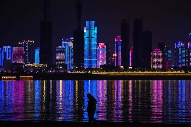 A man walks by the banks of the Yangtze river in Wuhan in China's central Hubei province on January 20, 2023, ahead of the Lunar New Year. (Photo by Hector Retamal/AFP Photo)