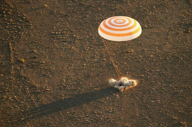 The Soyuz TMA-20M spacecraft is seen as it lands with Expedition 48 crew members, NASA astronaut Jeff Williams, Russian cosmonauts Alexey Ovchinin, and Oleg Skripochka of Roscosmos near the town of Zhezkazgan, Kazakhstan on Wednesday, September 7, 2016. Williams, Ovchinin, and Skripochka are returning after 172 days in space where they served as members of the Expedition 47 and 48 crews onboard the International Space Station. (Photo by Bill Ingalls/AFP Photo/NASA)