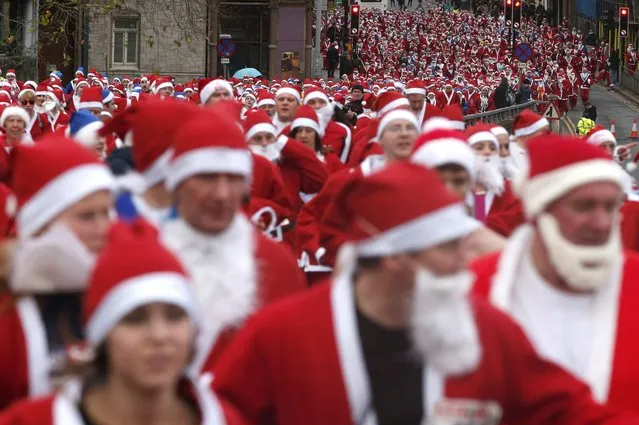 Thousands of runners dressed in Santa Claus outfits compete in the annual Santa Dash in Liverpool, northern England December 7, 2014. (Photo by Phil Noble/Reuters)