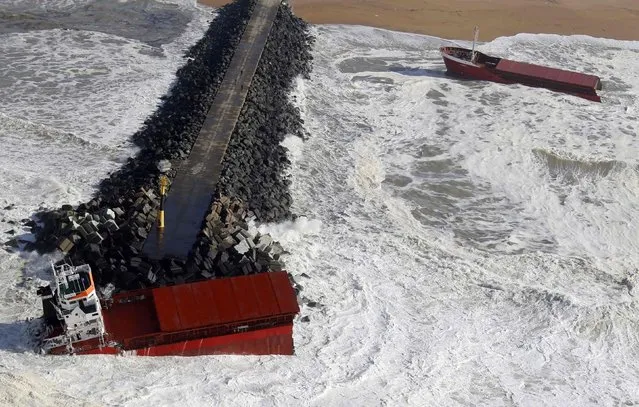An aerial view shows waves breaking against a Spanish cargo ship carrying fertiliser, which has broken in two, off the beach in Anglet on the Atlantic coast of France, in this February 5, 2014 file photo. (Photo by Regis Duvignau/Reuters)