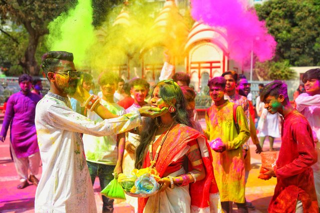 People spread abir (powdered colour) celebrating Dol Purnima festival at Dhakeshwari national temple in Dhaka, Bangladesh, on 07 March 2023. (Photo by Sony Ramany/NurPhoto via Getty Images)