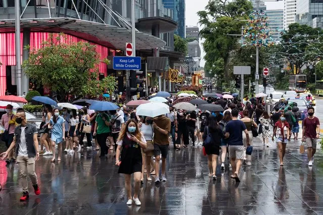Crowds, in the hundreds, thronged Singapore's shopping belt in preparation for the festive season despite the coronavirus (Covid-19) pandemic which has recorded a total of over 58,000 confirmed cases and 29 related deaths in Singapore on December 12, 2020. (Photo by Zakaria Zainal/Anadolu Agency via Getty Images)