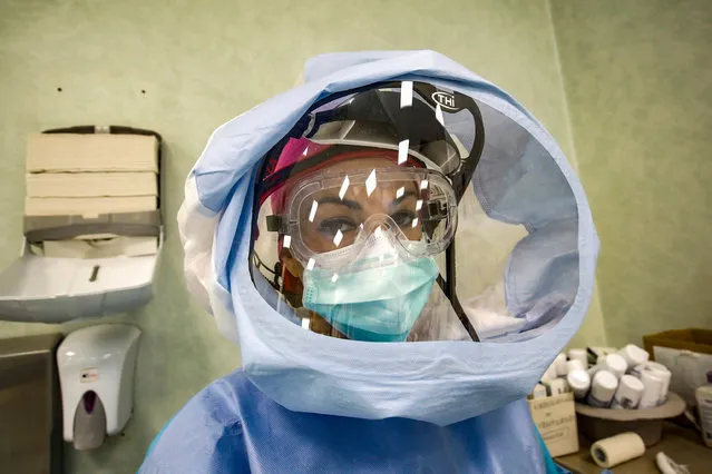 A medical worker wearing Personal Protective Equipment (PPE) poses for a photograph before starting to work in the intensive care unit (ICU) for patients infected with the coronavirus disease (COVID-19) at the Policlinico di Tor Vergata hospital, in Rome, Italy, 10 April 2020. (Photo by Giuseppe Lami/EPA/EFE)