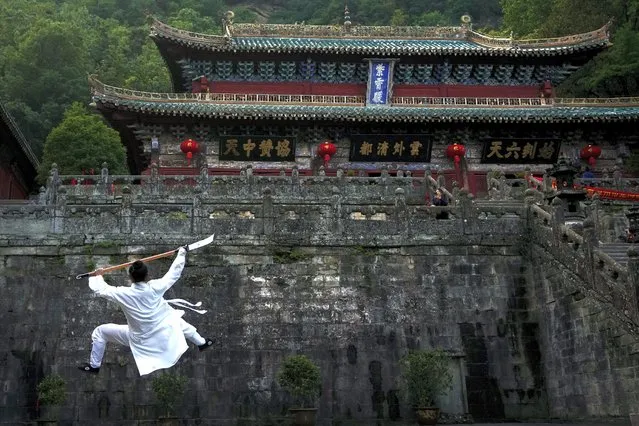 A taoist performs Wudang Tai Chi at Zixiao Palace during a media organized tour at Wudangshan Mountain in central China's Hubei Province, Thursday, May 11, 2023. Wudangshan, famed for its religious history as one of the centers for Taoism, Tai Chi exercise, and Taoist fighting styles. (Photo by Andy Wong/AP Photo)