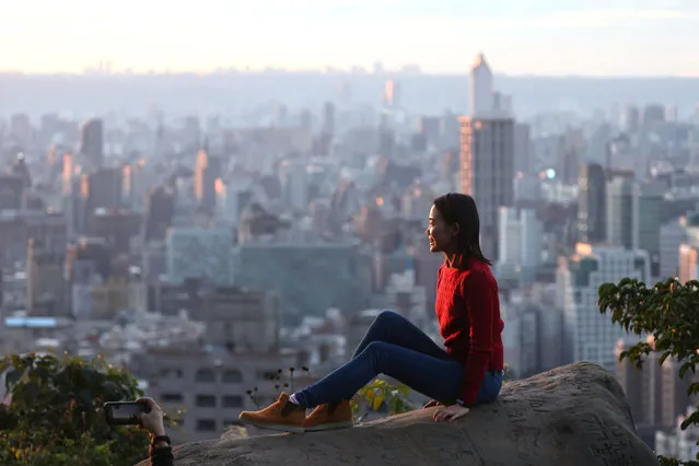 People take photos during sunset hours in Taipei, Taiwan, January 20, 2021. (Photo by Ann Wang/Reuters)