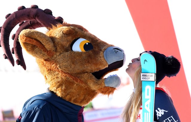 The American skier Lindsey Vonn celebrates winning the women’s downhill race in the FIS Alpine Ski World Cup on December 12, 2025. She is joined on the podium by Moritz, the competition’s official mascot, named after the Swiss resort in which it is held. (Photo by Denis Balibouse/Reuters)