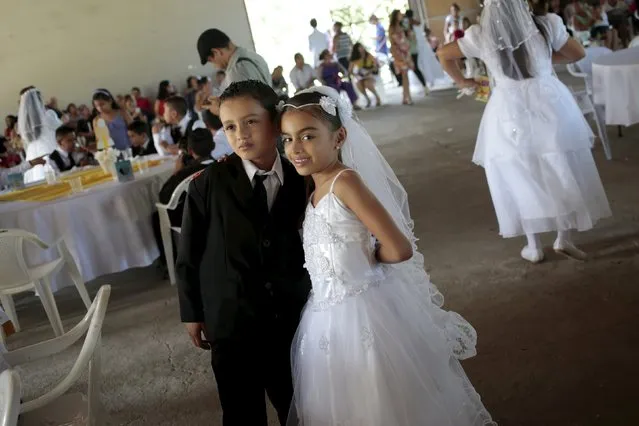Children pose for pictures after receiving their first Catholic Holy Communion at the Metropolitan Cathedral in Managua, Nicaragua, December 8, 2015. (Photo by Oswaldo Rivas/Reuters)