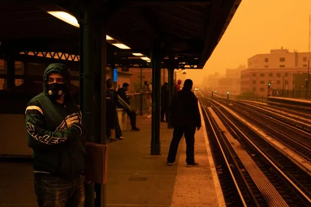 A person waiting for the subway wears a filtered mask as smoky haze from wildfires in Canada blankets a neighborhood on June 7, 2023 in the Bronx borough of New York City. New York topped the list of most polluted major cities in the world on Tuesday night, as smoke from the fires continues to blanket the East Coast. (Photo by David Dee Delgado/Getty Images)