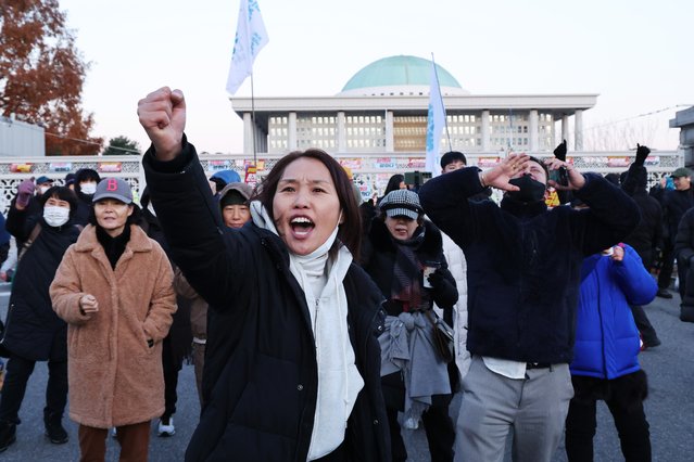 Protesters call for the resignation and impeachment of South Korean President Yoon Suk Yeol outside the National Assembly in Seoul, South Korea, 04 December 2024. President Yoon annnounced his intention to lift the emergency martial law hours after the National Assembly unanimously voted in favor of a resolution urging the president to withdraw the martial law during an emergency plenary session. Yoon had declared martial law the previous night, citing the need to root out pro-North Korean forces and uphold the constitutional order. (Photo by Han Myung-Gu/EPA/EFE)