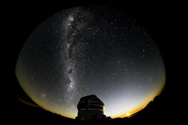 The night sky and artificial light of the city are seen outside the Gemini Observatory at the Cerro Las Campanas, on the outskirts of La Serena, Chile, April 14, 2011 in this handout photo provided by Gemini Observatory/AURA, December 14, 2015. (Photo by Manuel Paredes/Reuters/Gemini Observatory/AURA)
