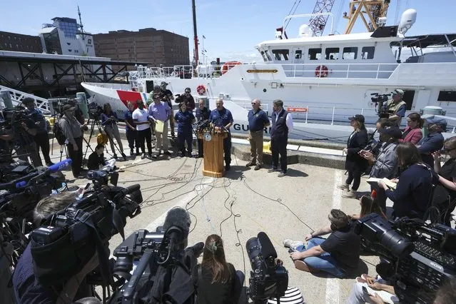 U.S. Coast Guard Capt. Jamie Frederick, center at microphone, faces reporters during a news conference, Wednesday, June 21, 2023, at Coast Guard Base Boston, in Boston. The U.S. Coast Guard says sounds and banging noises have been heard from the search area for Titanic submersible. (Photo by Steven Senne/AP Photo)