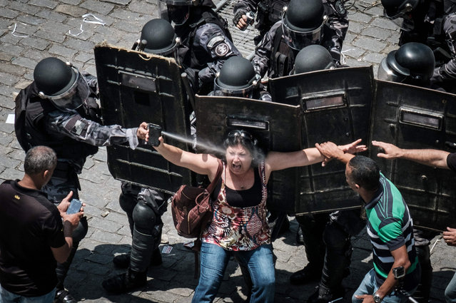 Rio de Janeiro state's public servants protest against austerity measures in front of the Rio de Janeiro state Assembly (ALERJ), where lawmakers began discussing the measures promoted by the governor Luiz Fernando Pezao pushing budget cuts in response to nearly empty public coffers, in Rio de Janeiro, Brazil, on November 16, 2016. (Photo by Yasuyoshi Chiba/AFP Photo)