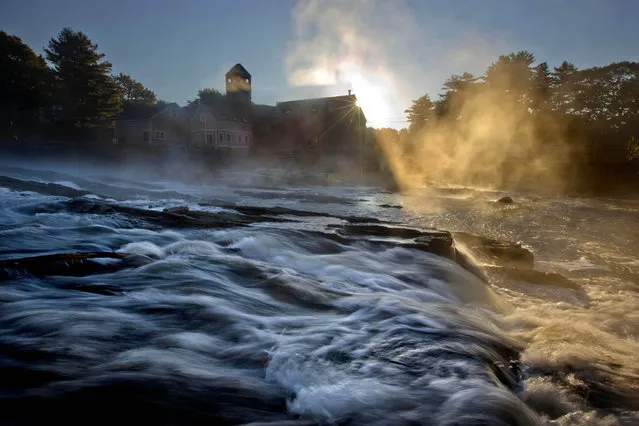 Steam rises from the Royal River as it flows past the Sparhawk Mill on a chilly autumn morning, Monday, October 6, 2014, in Yarmouth, Maine. (Photo by Robert F. Bukaty/AP Photo)