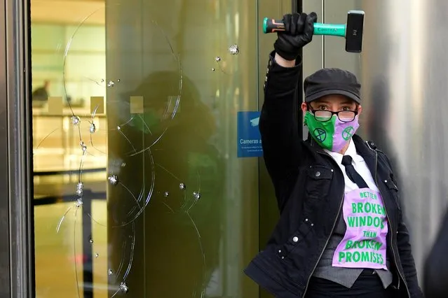 An activist from the Extinction Rebellion, a global environmental movement, takes part in a direct action at Barclays offices in Canary Wharf, London, Britain on April 7, 2021. (Photo by Toby Melville/Reuters)