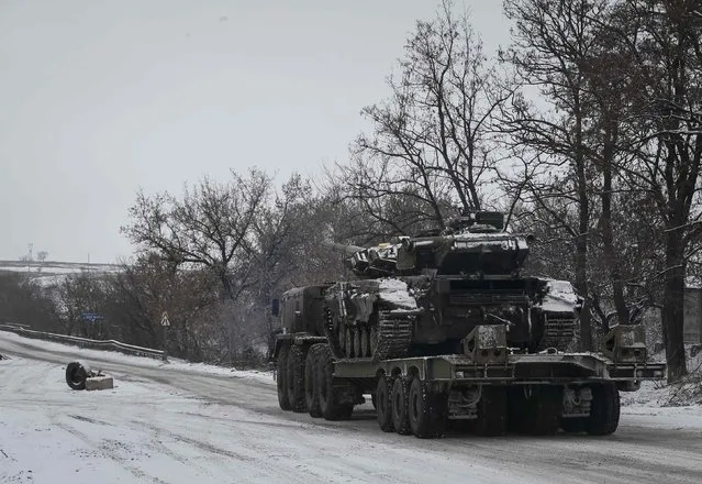 A military truck transports a tank near Debaltseve, eastern Ukraine, February 10, 2015. (Photo by Gleb Garanich/Reuters)