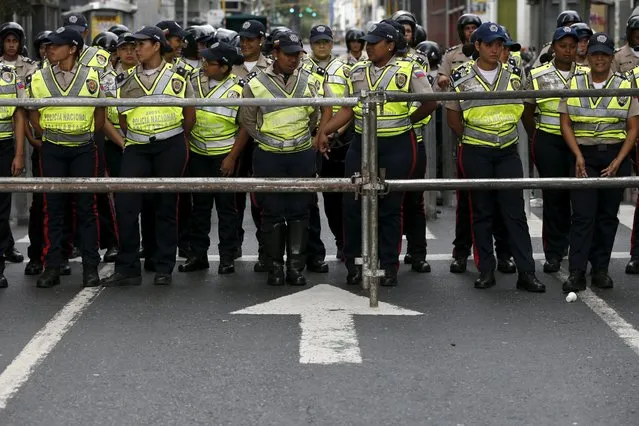 Members of the riot police stand guard outside the National Assembly before the start of the session in Caracas January 5, 2016. (Photo by Carlos Garcia Rawlins/Reuters)