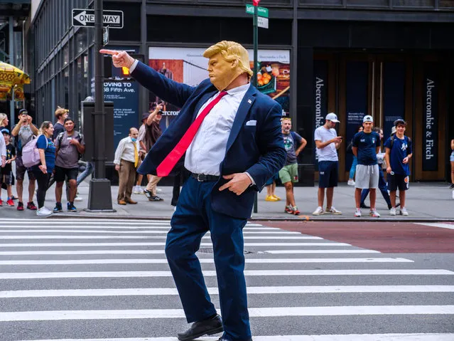 A Donald Trump impersonator gestures near a protest outside Trump Tower in New York City on August 3, 2023. Former President Trump pleaded not guilty to trying to overturn the results of his 2020 election loss in federal court in Washington, D.C. today. The scene at Trump Tower on Fifth Avenue New York as he was being indicted in Washington D.C. complete with Trump impersonator and demonstrators. (Photo by Milo Hess/ZUMA Press Wire/Rex Features/Shutterstock)
