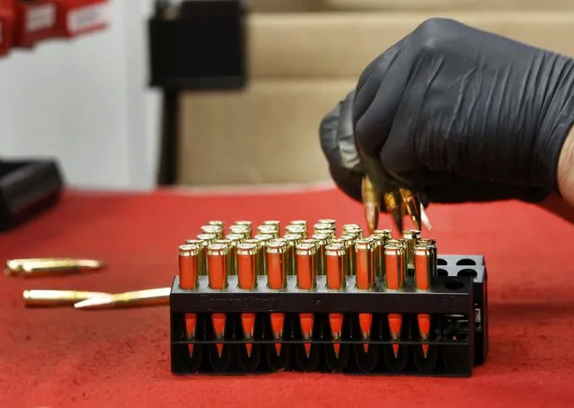 A worker puts finished 300 AAC Blackout rounds into packaging at Barnes Bullets in Mona, Utah, January 6, 2015. (Photo by George Frey/Reuters)