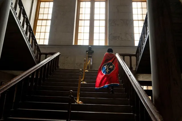 Oceana R. Gilliam climbs stairs at the Tennessee State Capitol while wearing the state flag ahead of a special session on public safety in Nashville, Tennessee, U.S., August 21, 2023. (Photo by Cheney Orr/Reuters)