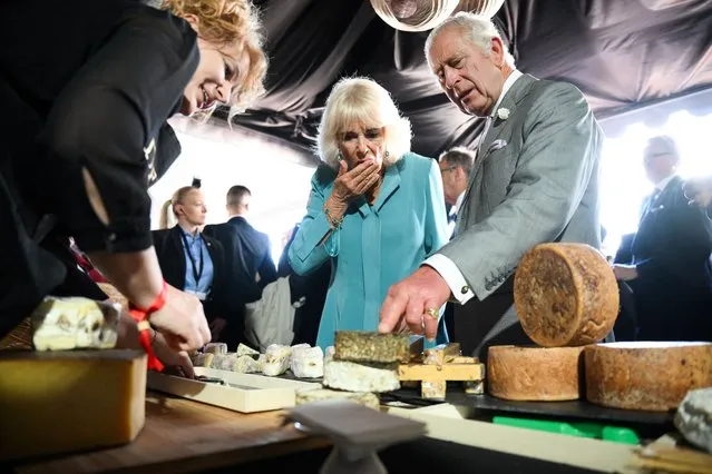 Britain's King Charles and his wife Queen Camilla sample some cheese during a visit to a festival in celebration of British and French culture and business at Place de la Bourse in Bordeaux, southwestern France, on September 22, 2023. Britain's King Charles III and his wife Queen Camilla are on a three-day state visit starting on September 20, 2023, to Paris and Bordeaux, six months after rioting and strikes forced the last-minute postponement of his first state visit as king. Daniel Leal/Pool via Reuters)