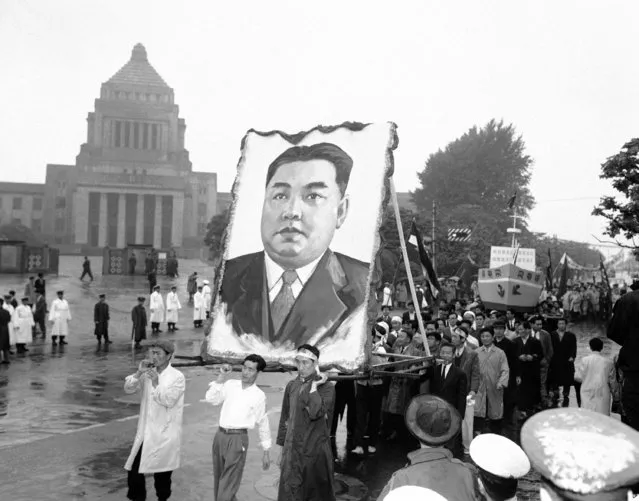 North Korean demonstrators carry portrait of that country's Communist Prime Minister, Kim Il Sung, during May Day festivities in Japan, May 2, 1959. In background is the Japanese National Diet (parliament) building in Tokyo. (Photo by AP Photo)