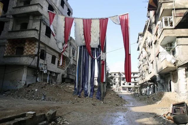 Clothes used for cover from snipers is pictured in the besieged town of Arbeen in the eastern Ghouta of Damascus January 17, 2015. (Photo by Yaseen Al-Bushy/Reuters)