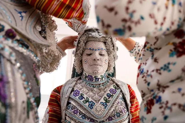 Melissa Guerrero, a U.S. citizen of Mexican origin, wearing traditional wedding makeup and a traditional costume, is prepared for her wedding ceremony in the village Donje Ljubinje, near Prizren, Kosovo on August 5, 2022. (Photo by Fatos Bytyci/Reuters)