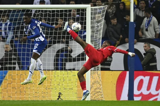 Antwerp's French forward #09 George Ilenikhena kicks the ball next to FC Porto's Nigerian defender #12 Zaidu Sanusi during the UEFA Champions League group H football match between FC Porto and Antwerp FC at the Dragao stadium in Porto on November 7, 2023. (Photo by Miguel Riopa/AFP Photo)