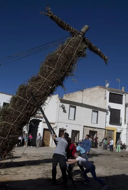 Youths help erect a cross in Tielmes, Spain on Easter Sunday  Sunday, April 5, 2015 marking the end of Holy week. (Photo by Paul White/AP Photo)