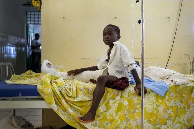 A boy who was injured in Saturday's 7.2-magnitude earthquake, sits on a bed at the Saint Antoine hospital in Jeremie, Haiti, Wednesday, August 18, 2021. (Photo by Matias Delacroix/AP Photo)
